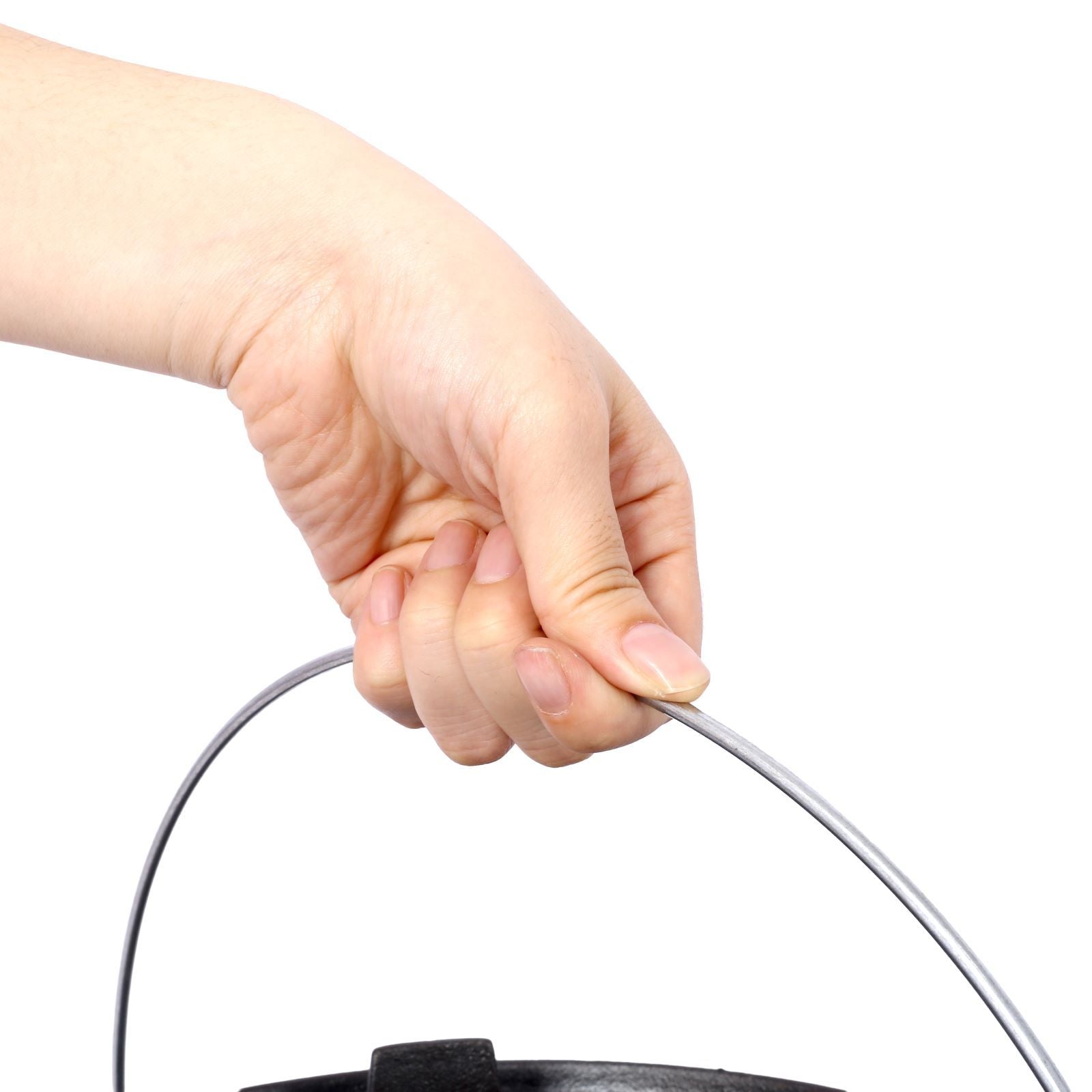 Hand holding the sturdy metal handle of the outdoor camping pot, demonstrating its portability and ease of use for campfire cooking.