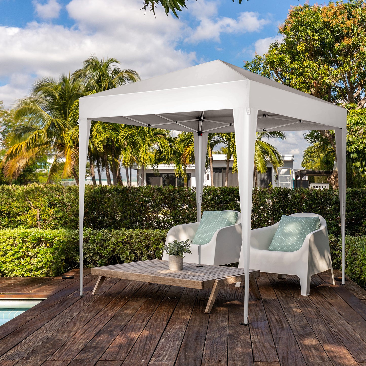 6.5x6.5ft white folding gazebo with Oxford cloth canopy and sprayed iron pipe frame, set up on a wooden deck with outdoor seating.