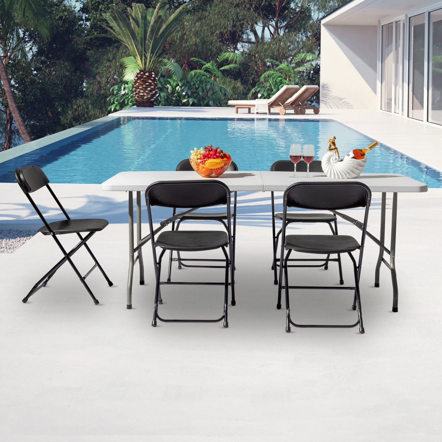 Poolside dining arrangement with a plastic folding table and black chairs, perfect for outdoor gatherings.