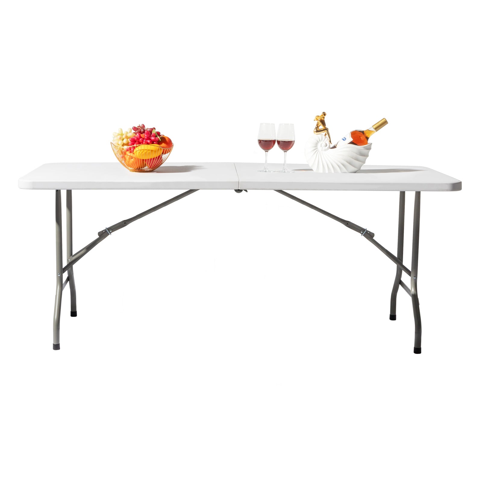 Plastic folding table set up for dining with wine glasses and fruit, ideal for indoor and outdoor use.