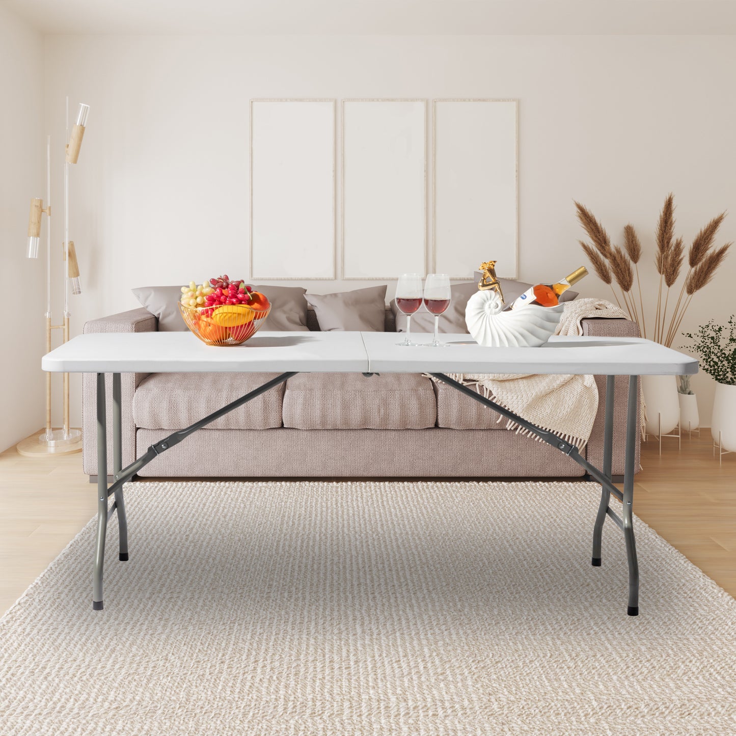 Indoor setup of a plastic folding table in a modern living room with a cozy sofa and decorative elements.